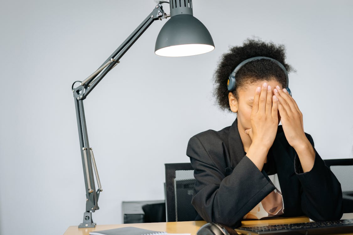 Eine Frau steht in ihrem Büro-Job kurz vor einem Burnout und ist erleichtert über ihre Berufsunfähigkeitsversicherung.